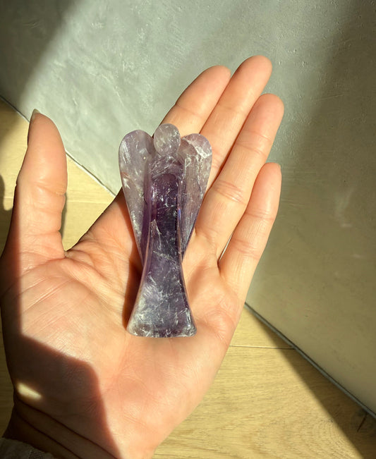 Hand holding Guardian of Peace Amethyst crystal angel — meaningful healing crystal gift from Aspen Angels Foundation for calm and serenity