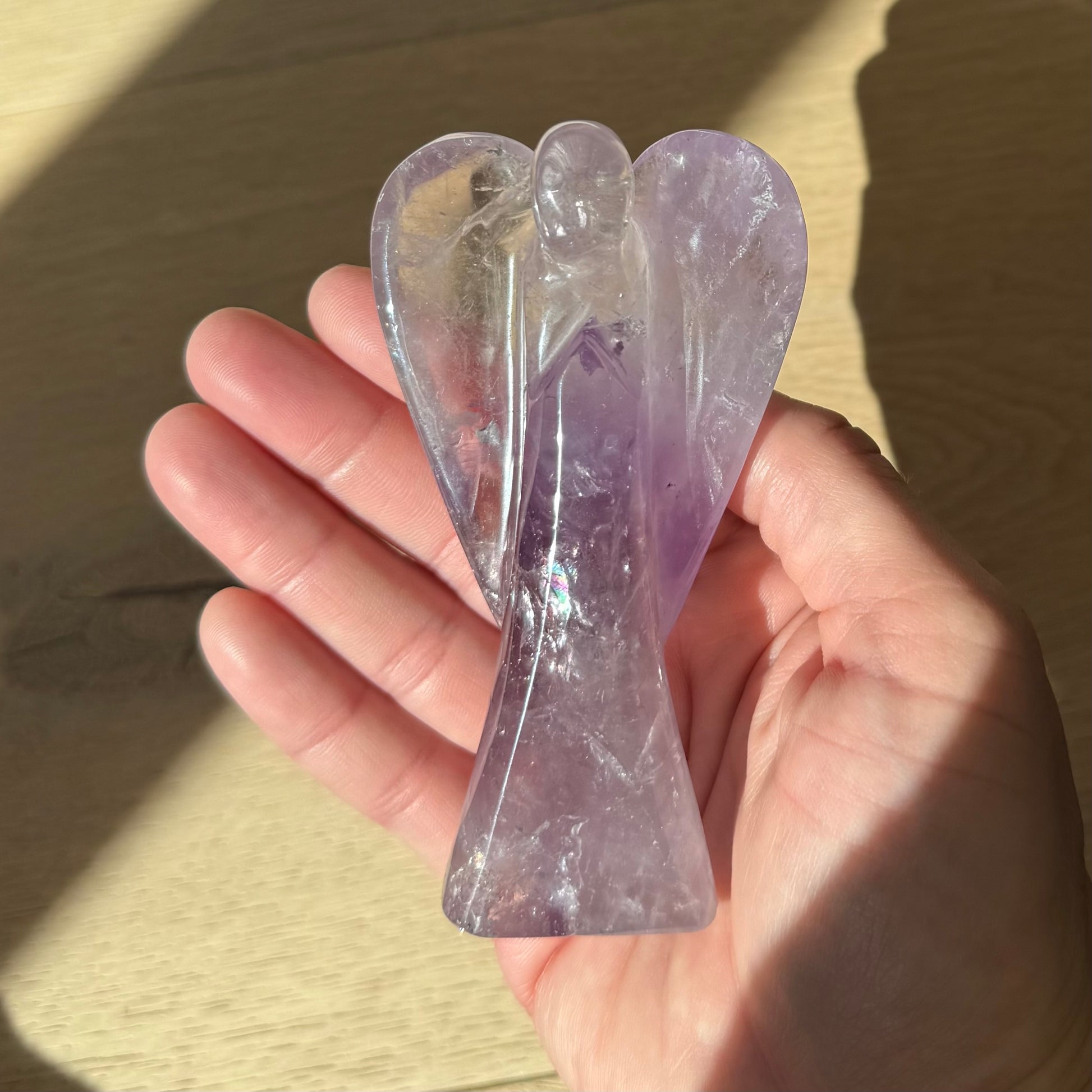 Hand holding Guardian of Peace Amethyst crystal angel — meaningful healing crystal keepsake from Aspen Angels Foundation for calm and serenity