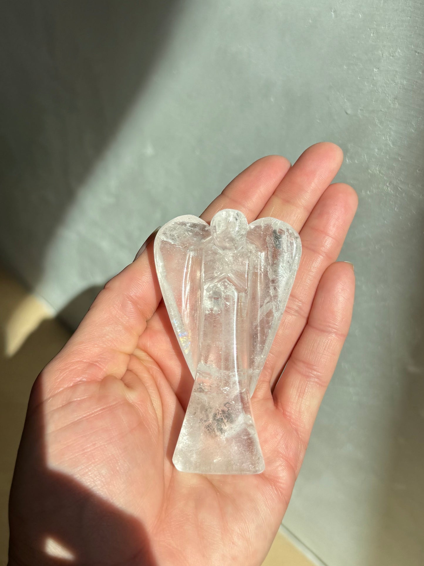 Clear Quartz Guardian Angel held in open hand — artisan crystal healing gift from Aspen Angels Foundation