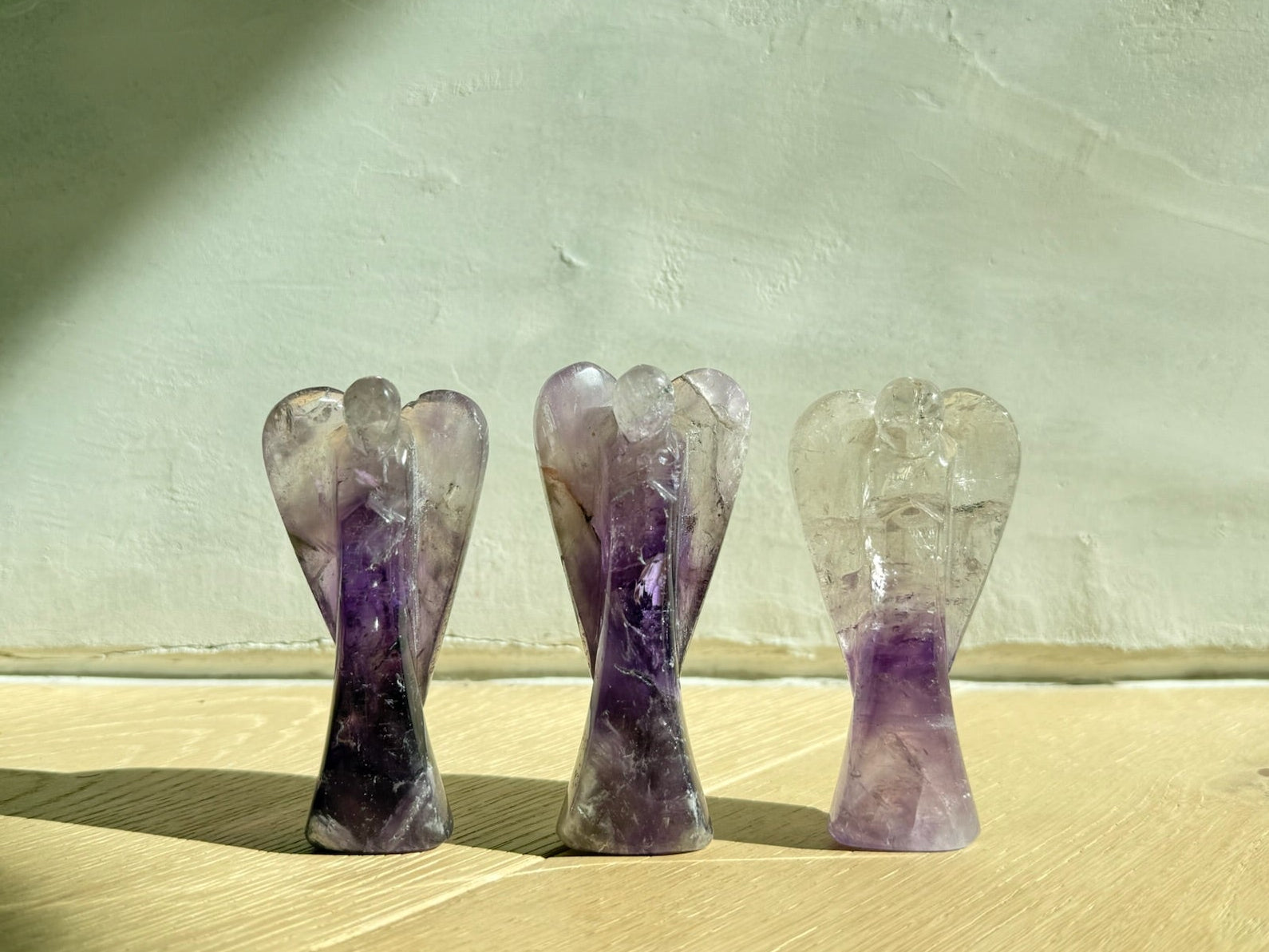 Three Guardian Angels — Guardian of Peace Amethyst, Guardian of Healing Rose Quartz, and Guardian of Light Clear Quartz — hand-carved crystal gifts from Aspen Angels Foundation